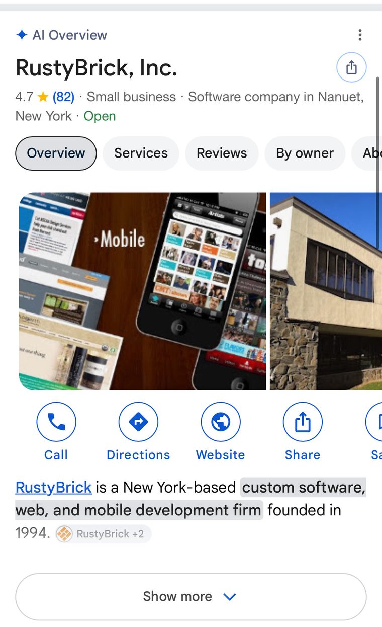 Ficha móvil de RustyBrick en Google con la etiqueta AI Overview arriba, pestañas Overview, Services, Reviews, By owner y About, botones de llamar, cómo llegar, web y compartir, una descripción generada con chip de cita RustyBrick +2 y un botón Show more al final
